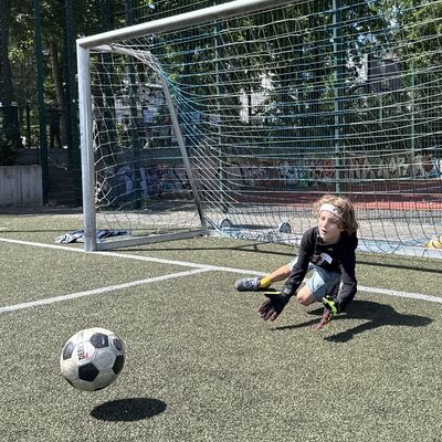 Bild vergr&ouml;&szlig;ern: Das Foto zeigt einen Jungen, der als Torwart einen Ball fangen will
